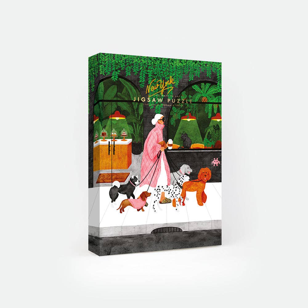 Boîte du puzzle Gardien de chien 1000 pièces All The Ways To Say, illustrée d’une promenade dans un parc verdoyant avec un dog sitter et plusieurs chiens.