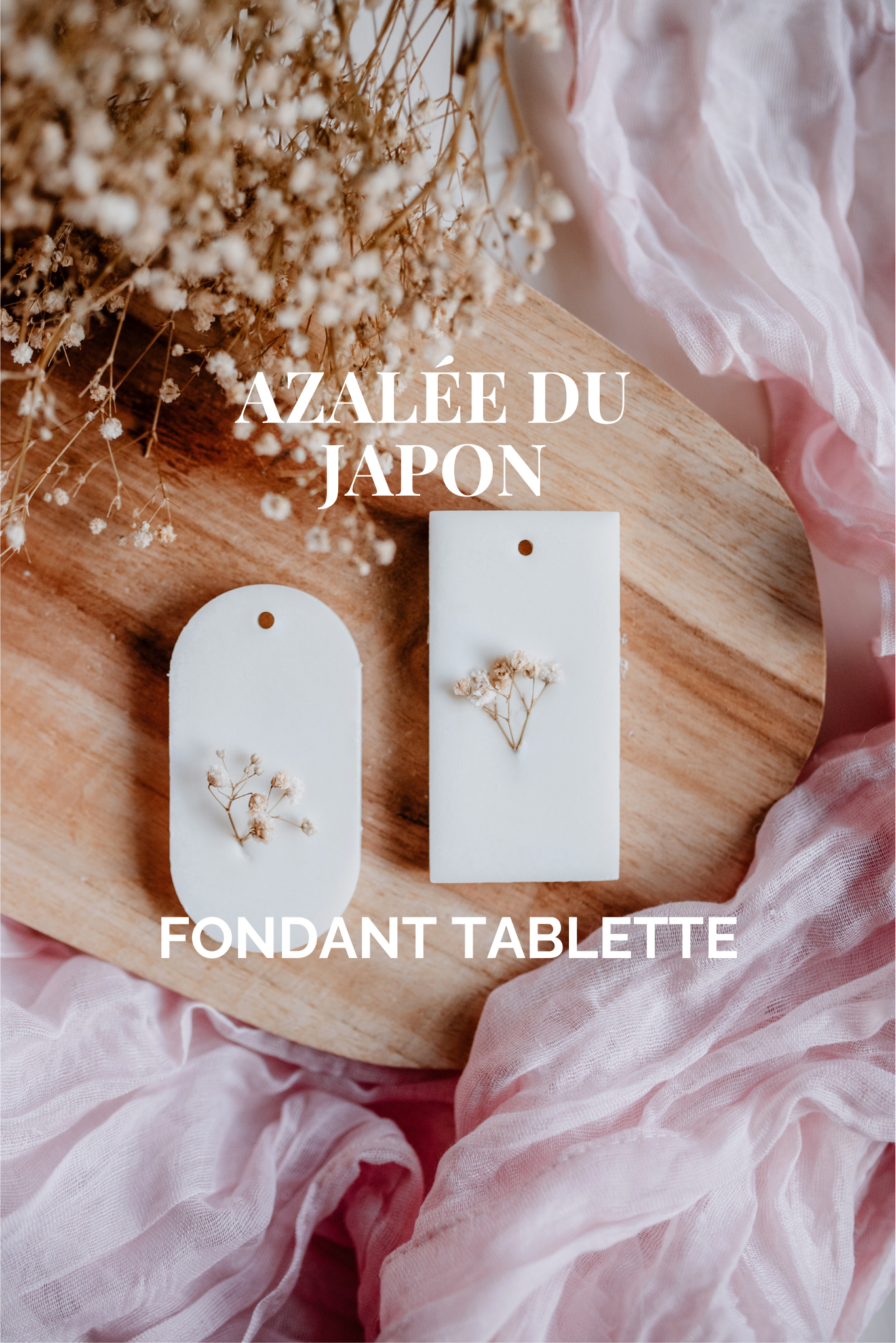 Gros plan de deux tablettes parfumées blanches décorées de fleurs séchées, posées sur un fond en bois avec tissu rose — visuel principal mettant en avant le produit.